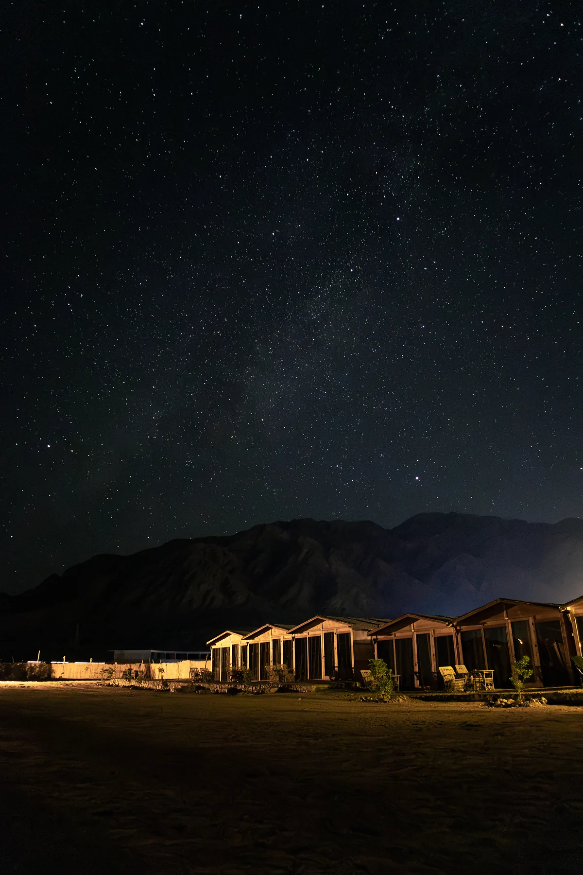 Glass-front rooms at the camp under a starry night